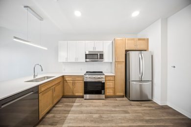 bright kitchen with a mix of white and light oak cabinets