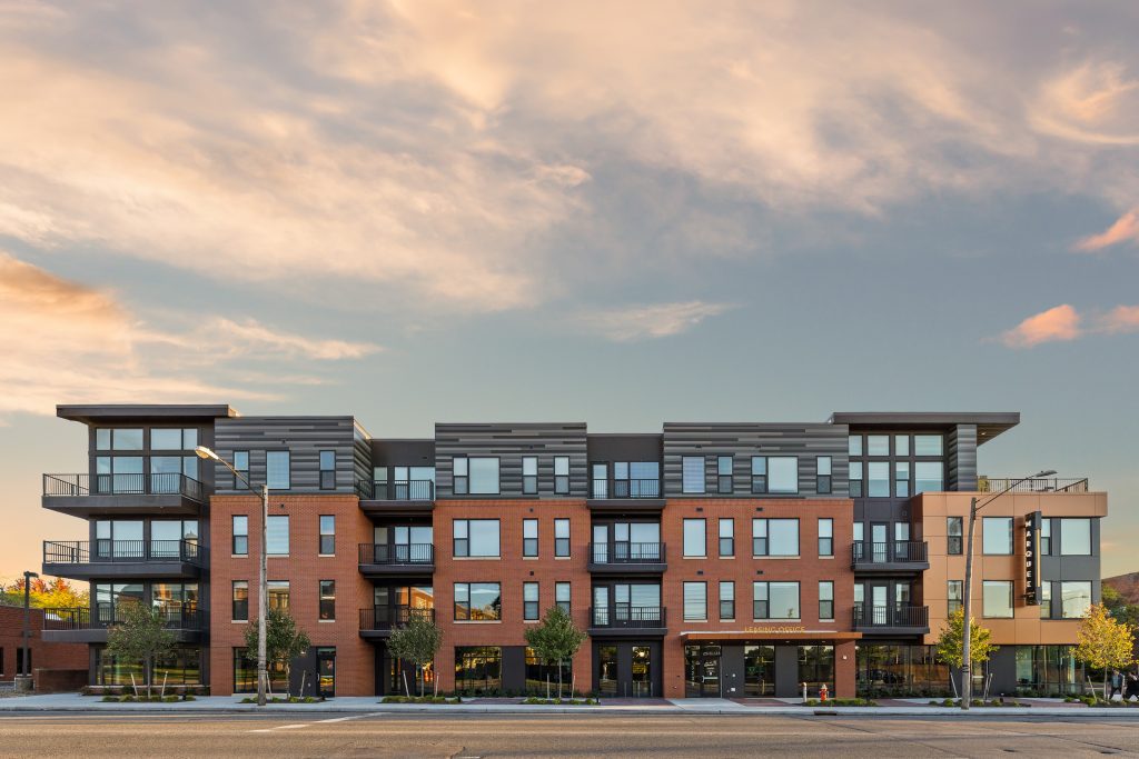 exterior of large apartment building at sunset