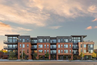 exterior of large apartment building at sunset