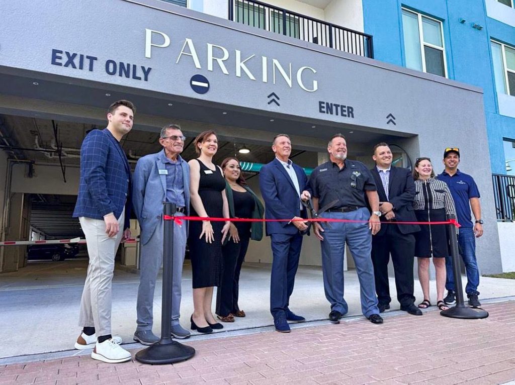 ribbon cutting in front of a parking garage