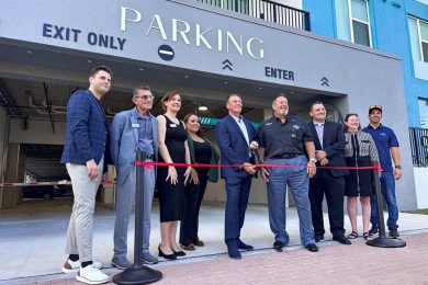 ribbon cutting in front of a parking garage